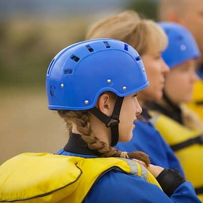 Girl ready to raft wearing helmet and life vest