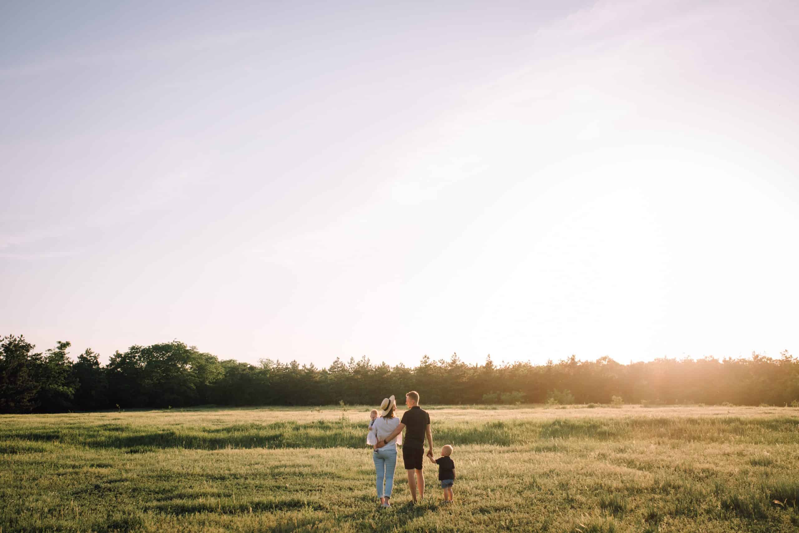 Family walking into sunset