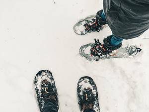 View of snowshoes on feet, winter