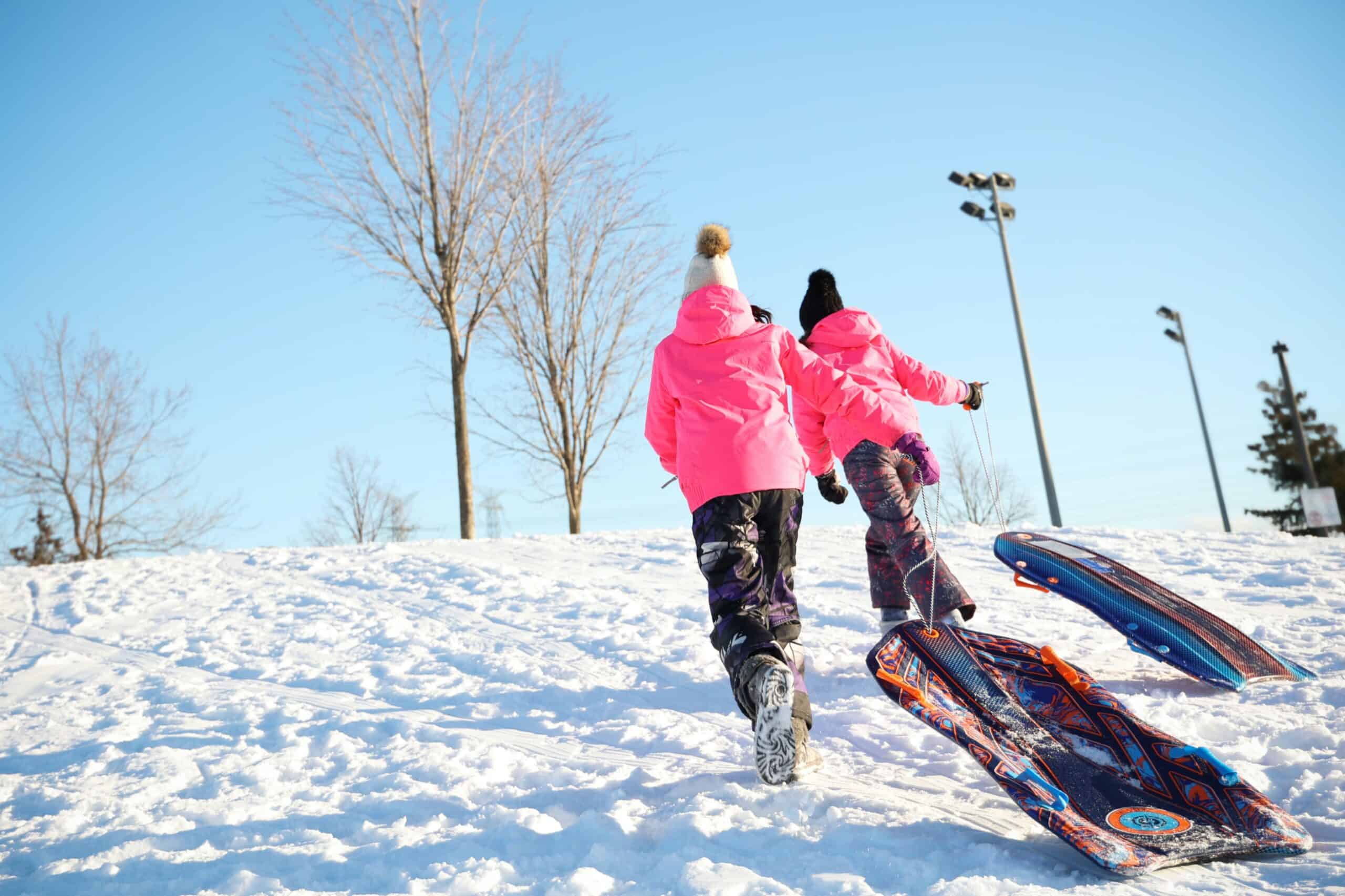 Two girls sledding