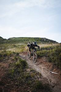 Man mountain biking on trail