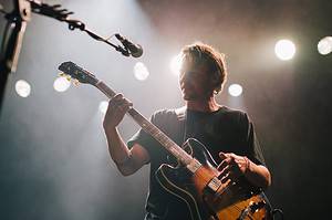 man playing guitar on stage