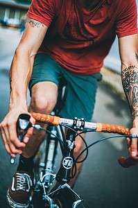 man with tattoos biking