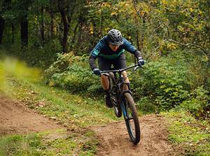 man mountain biking in forest