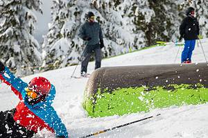 man skiing off a pipe