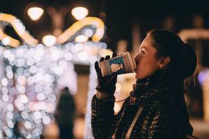 woman drinking out of snowman mug